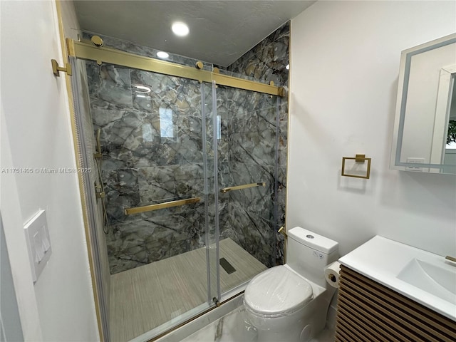 bathroom with a marble finish shower, vanity, and toilet