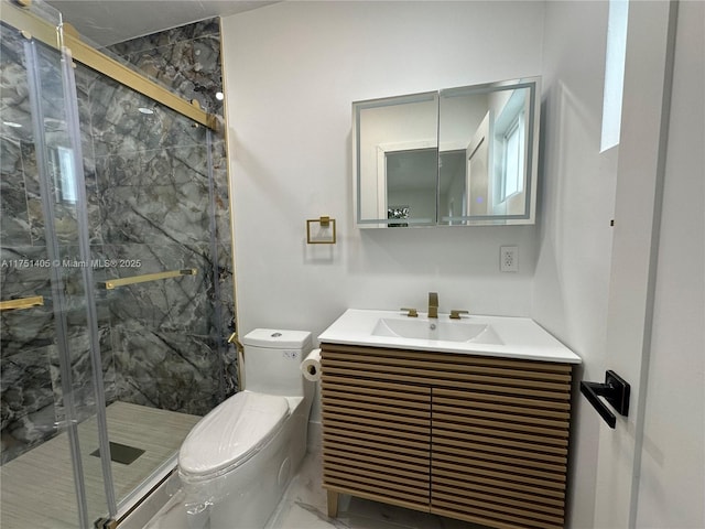 bathroom featuring toilet, a marble finish shower, and vanity