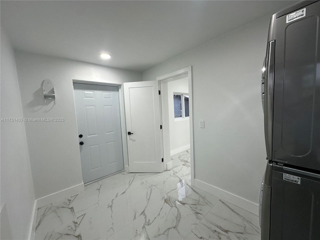 interior space featuring recessed lighting, marble finish floor, and baseboards