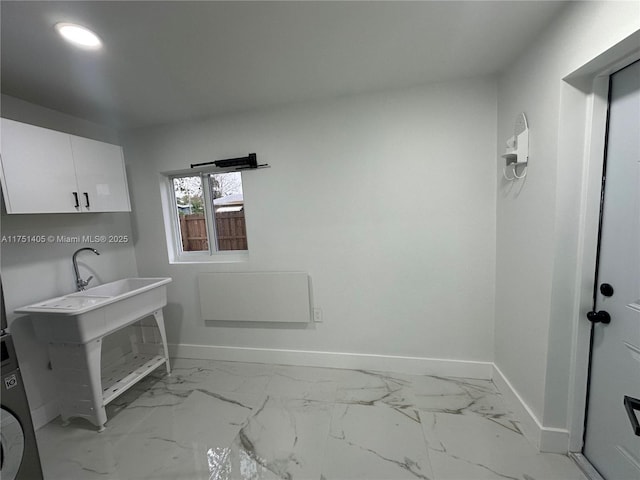 interior space with washer / clothes dryer, marble finish floor, and baseboards