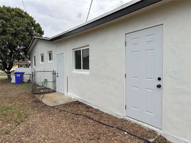 exterior space featuring fence and stucco siding