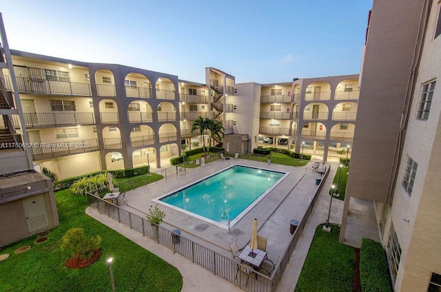 community pool featuring fence and a patio