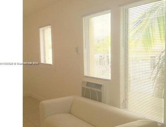 interior space featuring a wall mounted air conditioner and plenty of natural light