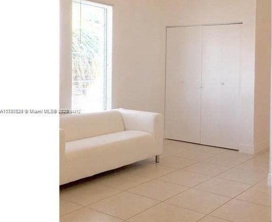 sitting room featuring a wealth of natural light and light tile patterned flooring