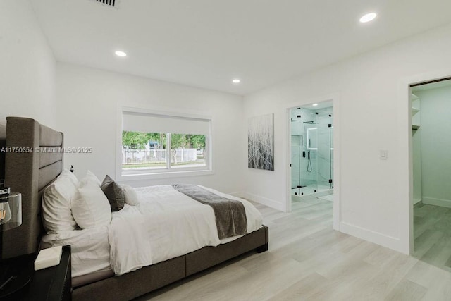 bedroom with light wood-style floors, baseboards, and recessed lighting