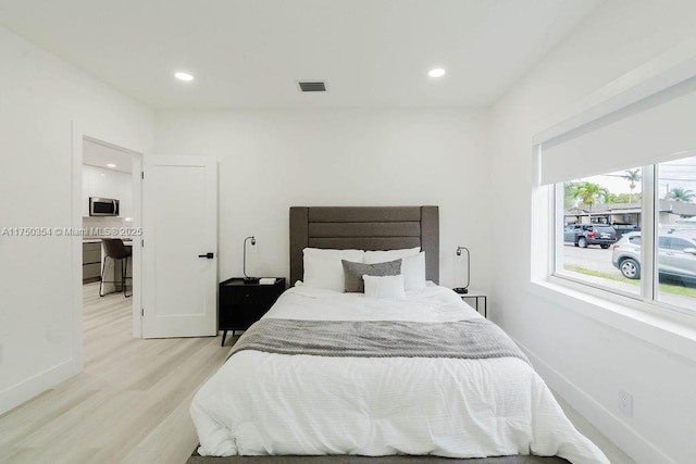 bedroom featuring recessed lighting, visible vents, light wood-style flooring, and baseboards