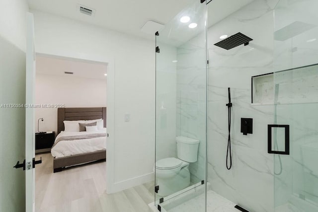 full bathroom with toilet, wood finished floors, visible vents, a marble finish shower, and ensuite bath