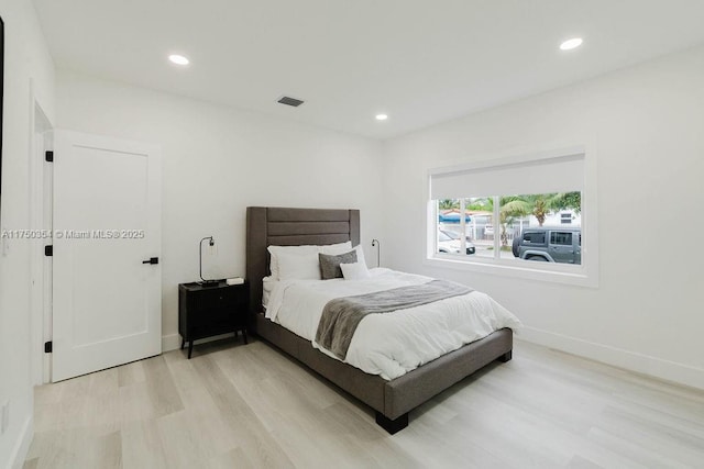 bedroom with recessed lighting, visible vents, light wood-style flooring, and baseboards