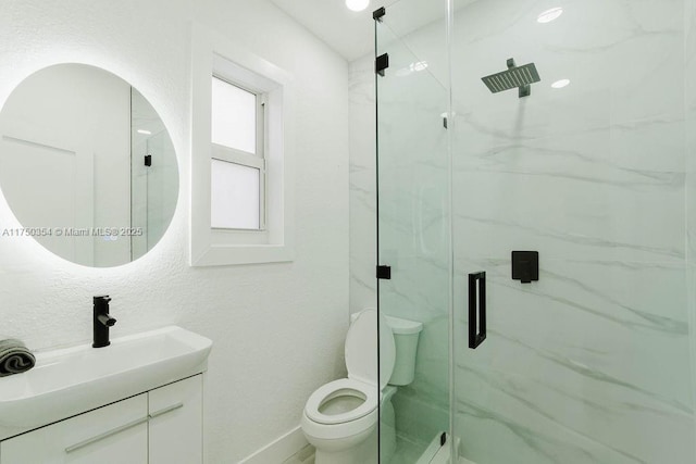 full bathroom with vanity, a marble finish shower, toilet, and baseboards