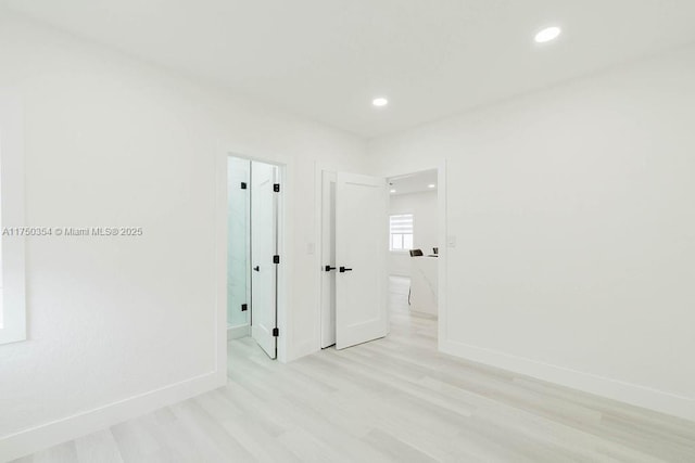 interior space with recessed lighting, baseboards, and light wood finished floors