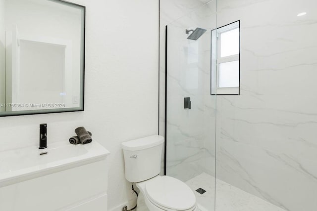 full bath featuring toilet, a marble finish shower, and vanity