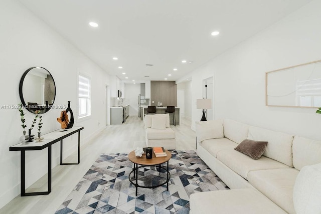 living area featuring light wood-style floors and recessed lighting