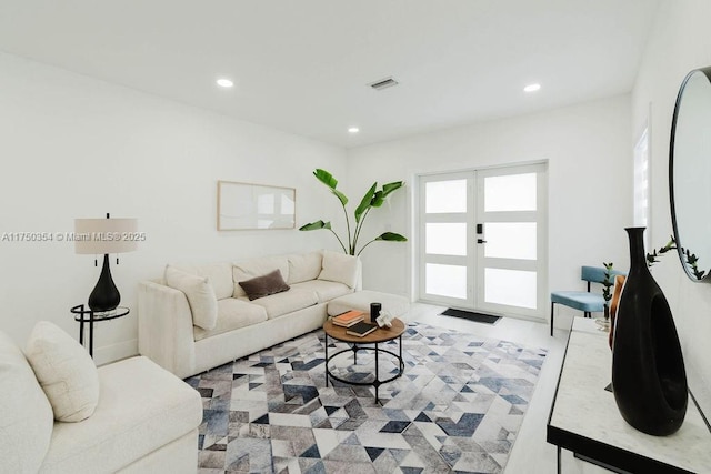 living room with french doors, visible vents, and recessed lighting