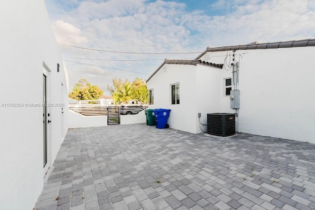 view of patio with fence and central AC unit