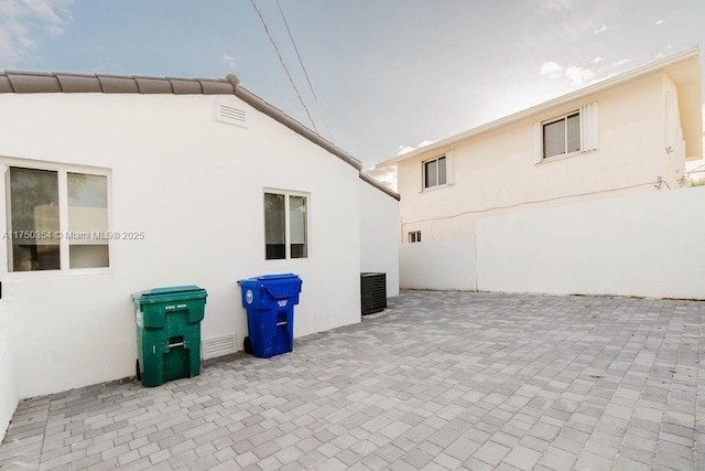 view of home's exterior with a patio area, cooling unit, and stucco siding