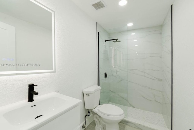 full bath featuring a marble finish shower, marble finish floor, visible vents, and toilet