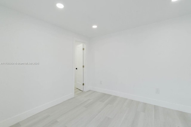 unfurnished room featuring light wood-style floors, baseboards, and recessed lighting