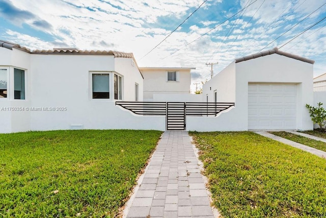 view of front of property featuring a front lawn and stucco siding