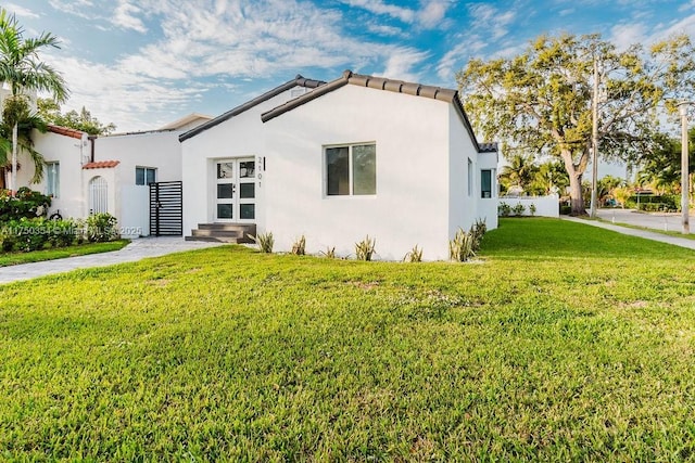 view of front of property with a front lawn and stucco siding