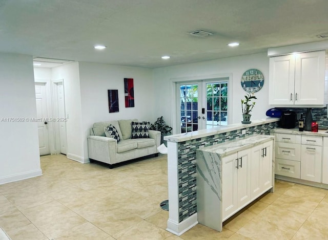 kitchen featuring visible vents, white cabinets, open floor plan, french doors, and recessed lighting