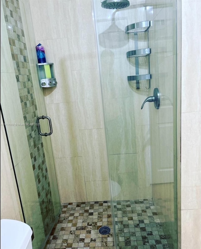 full bath with a shower stall