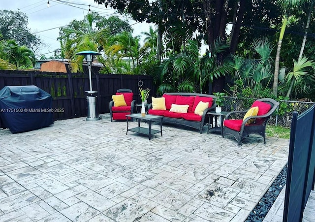 view of patio featuring a fenced backyard and an outdoor living space