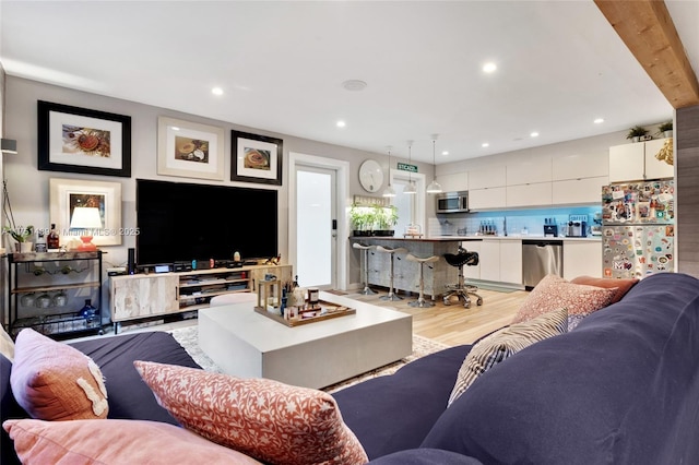 living room with light wood-style floors and recessed lighting