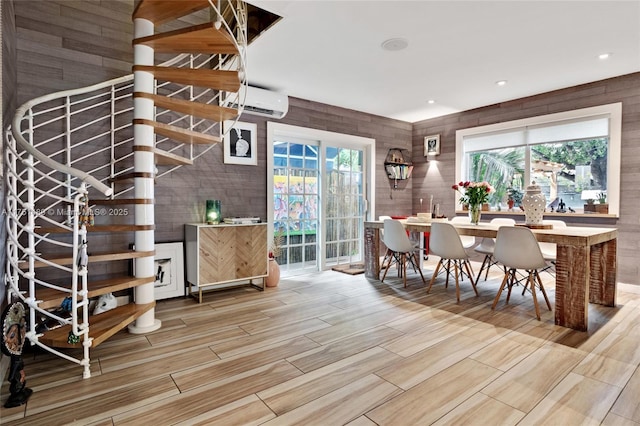 dining room with a wall mounted AC, recessed lighting, a wealth of natural light, and wood tiled floor