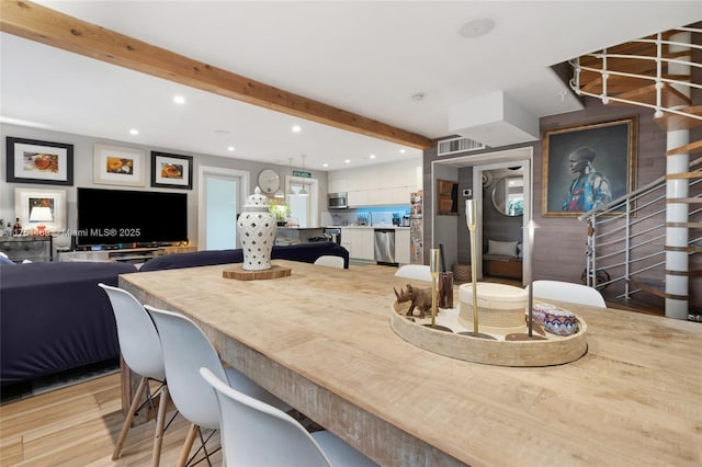 dining space featuring light wood-style floors, stairway, beam ceiling, and recessed lighting