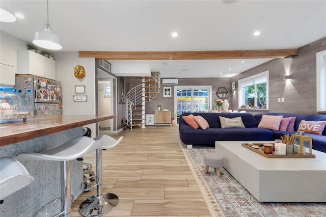 living room with recessed lighting, stairway, wood tiled floor, an AC wall unit, and beamed ceiling