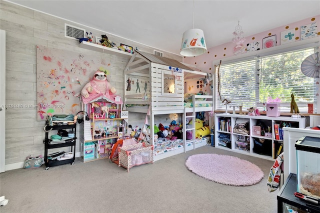 carpeted bedroom with wood walls