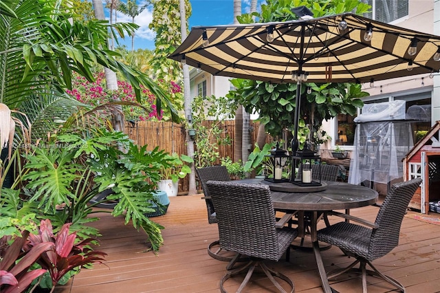 deck featuring fence and outdoor dining space