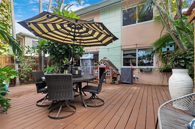 wooden deck featuring fence and outdoor dining space