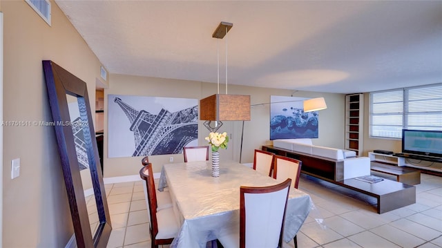 dining room with light tile patterned floors and visible vents