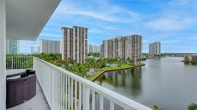 balcony with a water view and a city view