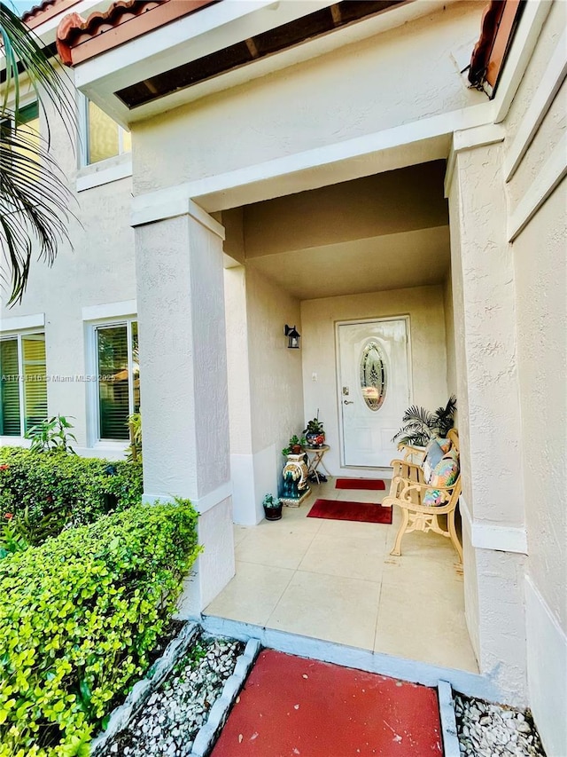 entrance to property with stucco siding