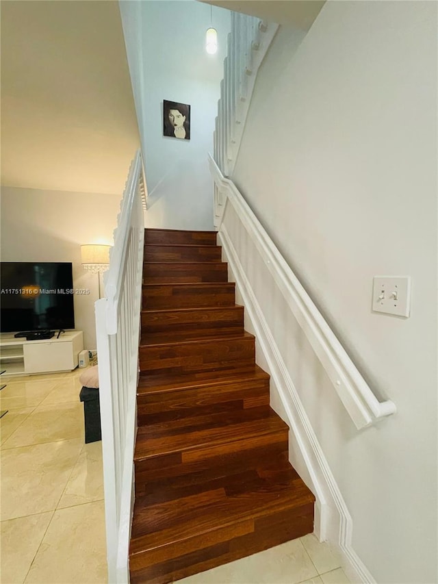 stairway with tile patterned flooring