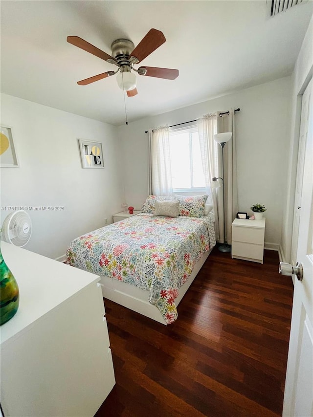 bedroom with dark wood-type flooring, visible vents, and a ceiling fan