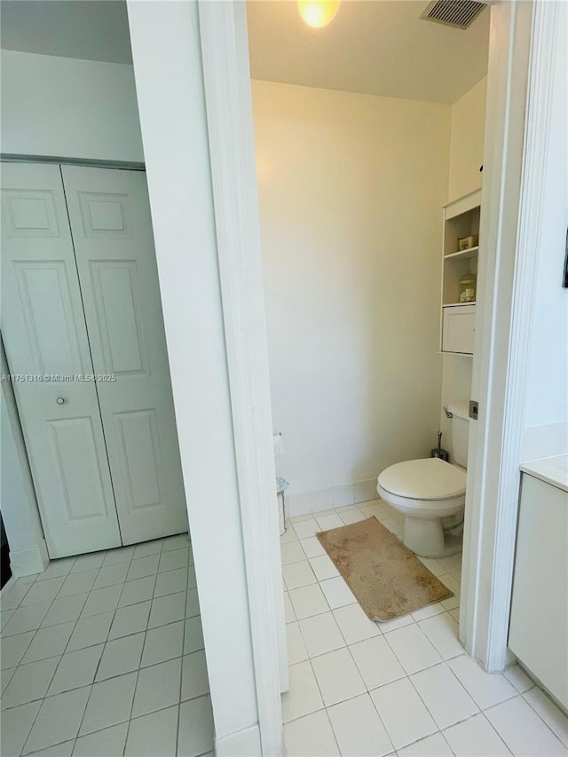 bathroom featuring visible vents, toilet, and tile patterned floors