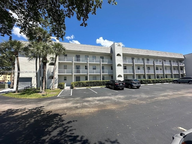 view of building exterior featuring uncovered parking