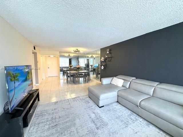 living area featuring light tile patterned floors and a textured ceiling