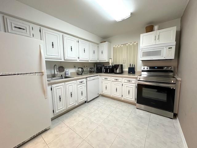 kitchen featuring light countertops, white appliances, a sink, and white cabinetry