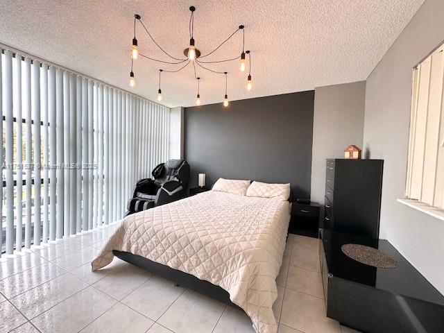 bedroom featuring a textured ceiling and light tile patterned floors