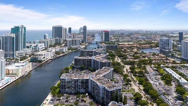 birds eye view of property featuring a water view and a city view