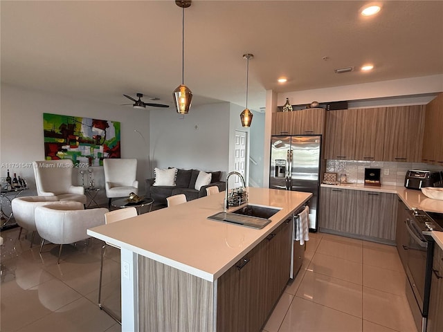 4640 NW 84th Ave Unit 13, Doral, FL 33166 - kitchen featuring a sink, stainless steel appliances, open floor plan, light tile patterned floors, and recessed lighting