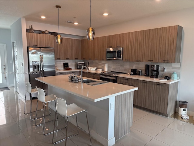 4640 NW 84th Ave Unit 13, Doral, FL 33166 - kitchen featuring appliances with stainless steel finishes, modern cabinets, a sink, a kitchen bar, and recessed lighting