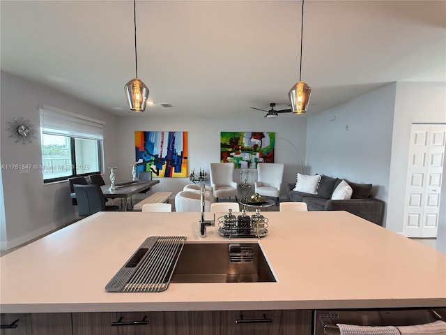 4640 NW 84th Ave Unit 13, Doral, FL 33166 - kitchen featuring open floor plan, light countertops, pendant lighting, and a ceiling fan