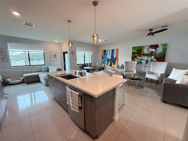 4640 NW 84th Ave Unit 13, Doral, FL 33166 - kitchen with open floor plan, stainless steel dishwasher, a sink, an island with sink, and light countertops