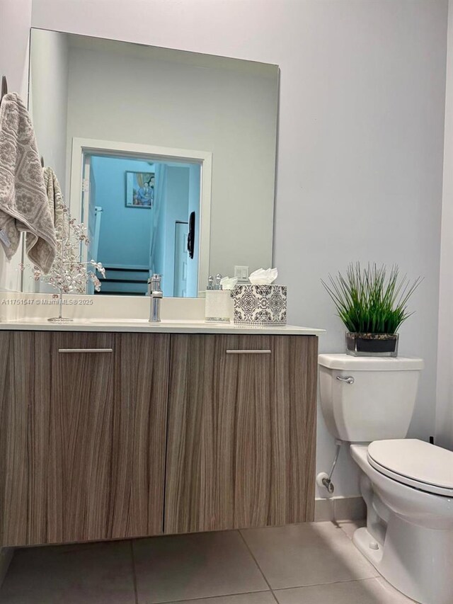 4640 NW 84th Ave Unit 13, Doral, FL 33166 - bathroom with toilet, vanity, tile patterned flooring, and baseboards