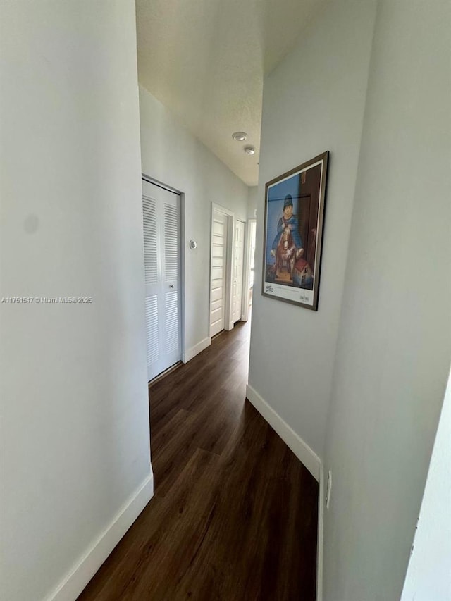 4640 NW 84th Ave Unit 13, Doral, FL 33166 - corridor with baseboards and dark wood-type flooring